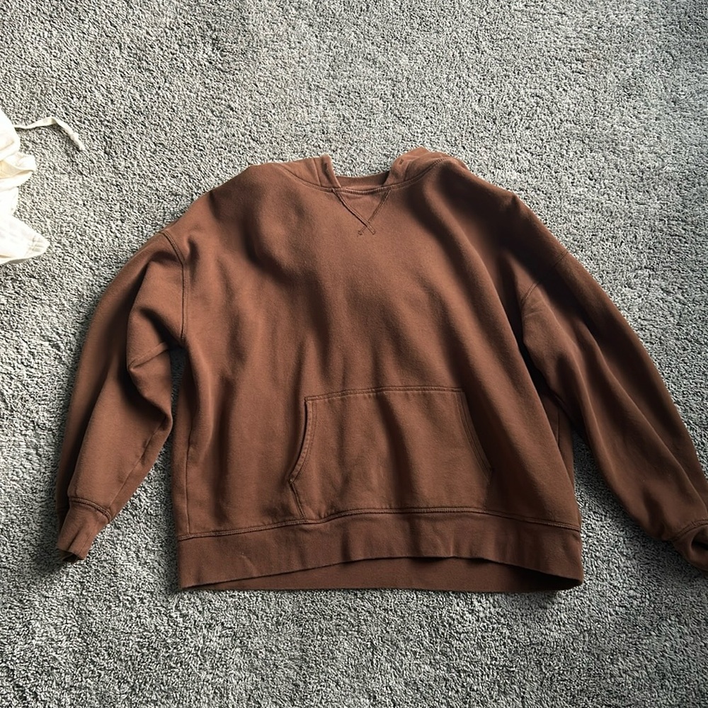 American E, brown hoodie